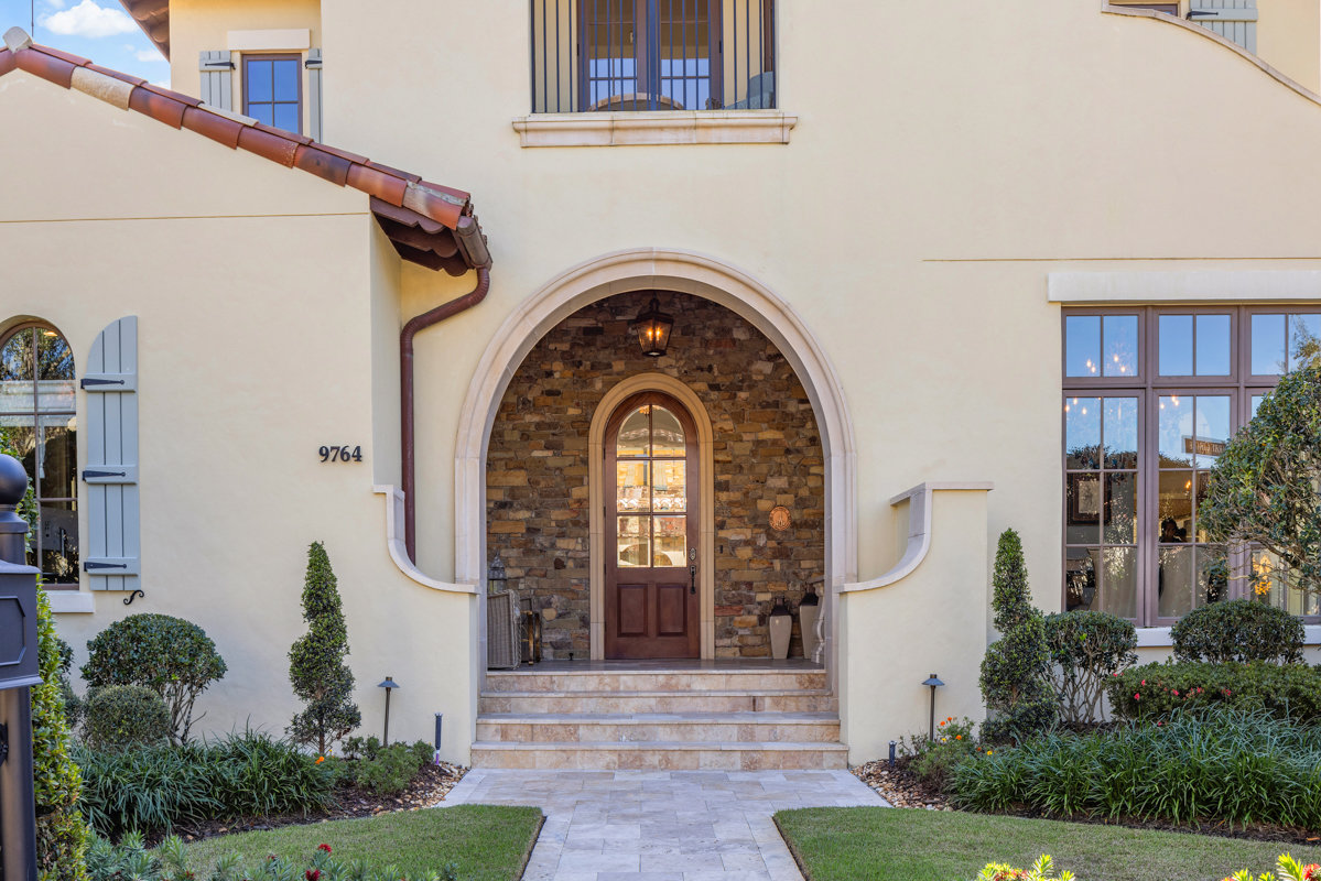 front of home with mediterranean architecture and stonework